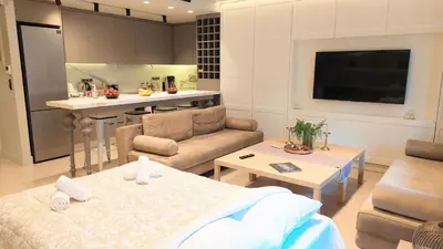 a kitchen and living room with a couch and a table at Luxurious apartment in Acropolis in Athens