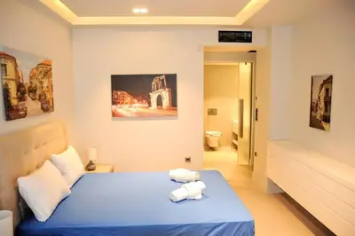 a bedroom with a blue bed with towels on it at Luxurious apartment in Acropolis in Athens