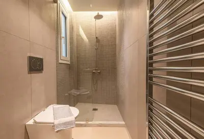 a bathroom with a shower with a toilet and a sink at Luxurious apartment in Acropolis in Athens
