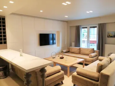 a living room with a couch and a table at Luxurious apartment in Acropolis in Athens
