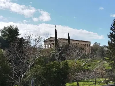 a building on top of a hill with trees at Luxurious minimal apartment in Acropolis in Athens