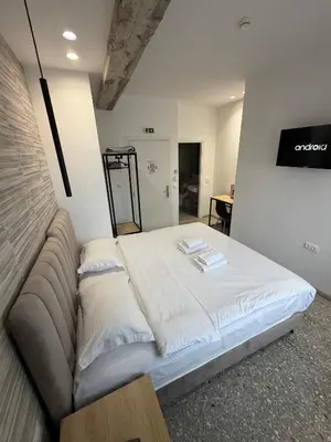 a large bed in a room with a couch at athensdot in Athens