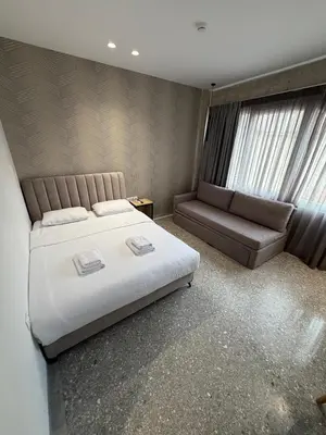 a bedroom with a large bed and a couch at athensdot in Athens