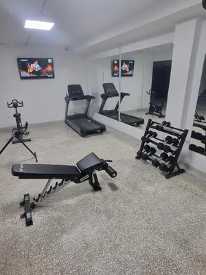 a gym with several exercise bikes in a room at athensdot in Athens