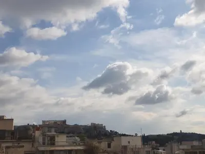 a view of a city under a cloudy sky at athensdot in Athens