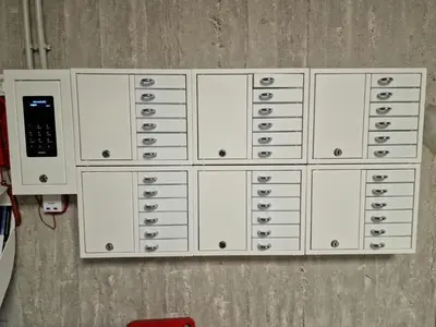 a row of white lockers in a room at athensdot in Athens