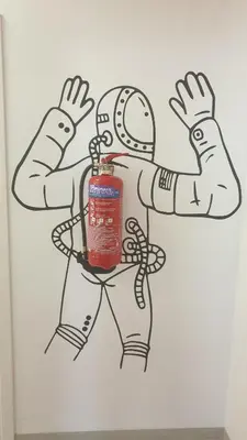 a drawing of a football player with a fire extinguisher at athensdot in Athens