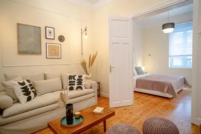 a living room with a couch and a bed at The H Experience Boutique Apartments Athens - free parking and fiber internet in Athens