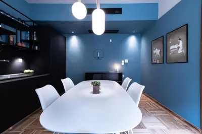 a dining room with a white table and white chairs at The H Experience Boutique Apartments Athens - free parking and fiber internet in Athens