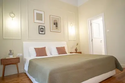 a bedroom with a large bed and a window at The H Experience Boutique Apartments Athens - free parking and fiber internet in Athens
