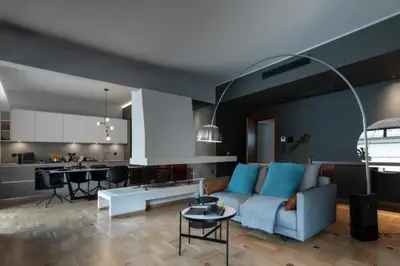 a living room with a couch and a kitchen at The H Experience Boutique Apartments Athens - free parking and fiber internet in Athens