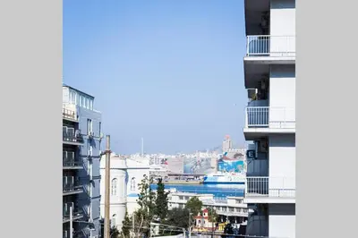 a view of a city from between two buildings at Neoclassical apartment with 3 bedrooms in Piraeus in Piraeus