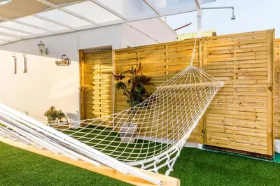 a hammock in a room with a wooden wall at Neoclassical apartment with 2 bedrooms in Piraeus in Piraeus