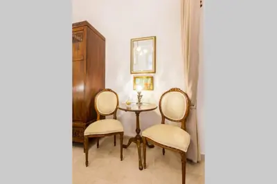a dining room with a table and two chairs at Neoclassical apartment with 2 bedrooms in Piraeus in Piraeus
