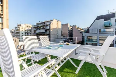 a white table and chairs on a balcony at Neoclassical apartment with 2 bedrooms in Piraeus in Piraeus