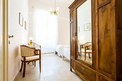 a bedroom with a dresser and a bedroom with a bed at Neoclassical flat with 2 bedrooms in Piraeus in Piraeus