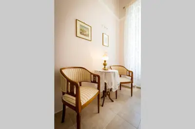 a dining room with a table and two chairs at Neoclassical flat with 2 bedrooms in Piraeus in Piraeus
