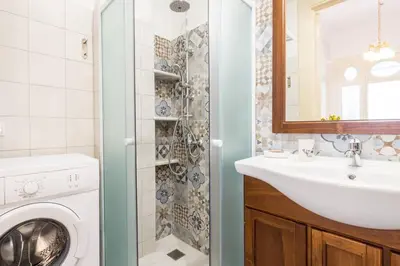 a bathroom with a washing machine and a sink at Neoclassical flat with 2 bedrooms in Piraeus in Piraeus