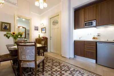 a kitchen with a table and a dining room at Neoclassical flat with 2 bedrooms in Piraeus in Piraeus