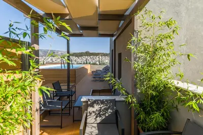 a balcony with tables and chairs and plants at Athens Panorama Project in Athens