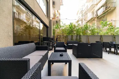a patio with tables and chairs on a building at Athens Panorama Project in Athens