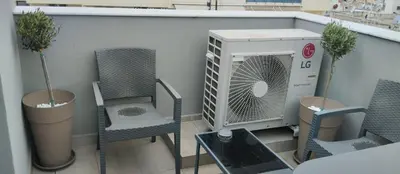 a balcony with chairs and a heater on a building at Athens Panorama Project in Athens