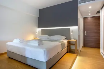 a bedroom with a bed with white sheets and pillows at Athens Panorama Project in Athens