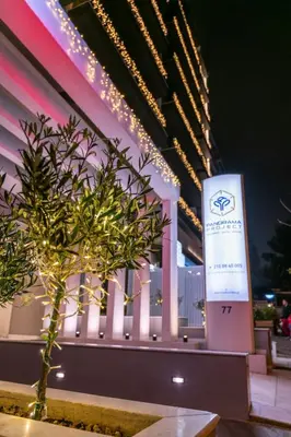 a sign in front of a building with a tree at Athens Panorama Project in Athens