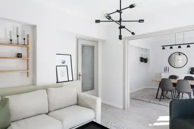 a living room with a white couch and a table at Deluxe & Stylish 2BD Apartment in Pangrati by UPSTREET in Athens
