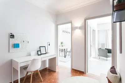 a white office with a desk and a dining room at Deluxe & Stylish 2BD Apartment in Pangrati by UPSTREET in Athens