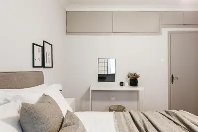 a white bedroom with a bed and a window at Deluxe & Stylish 2BD Apartment in Pangrati by UPSTREET in Athens