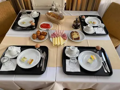 a table with plates of food on it at Adams Hotel in Athens
