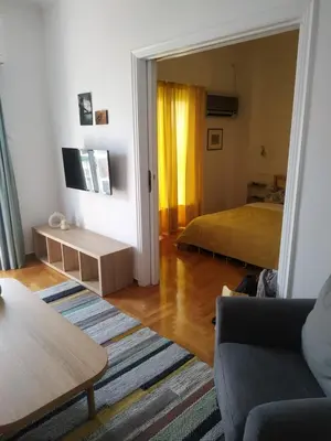a living room with a bed and a couch at Michali's Koukaki Apartment (metro Sygrou/Fix) in Athens