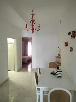 a white dining room with a white table and chairs at Michali's Koukaki Apartment (metro Sygrou/Fix) in Athens
