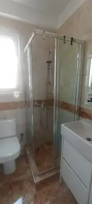 a bathroom with a shower and a toilet and a sink at Michali's Koukaki Apartment (metro Sygrou/Fix) in Athens