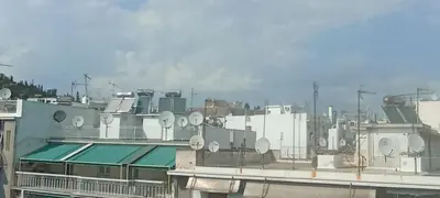 a view of a building with satellites on the roof at Michali's Koukaki Apartment (metro Sygrou/Fix) in Athens