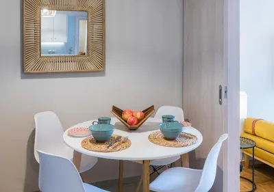 a white table with white chairs and a mirror at Brand new aprtm touching Acropolis in Athens
