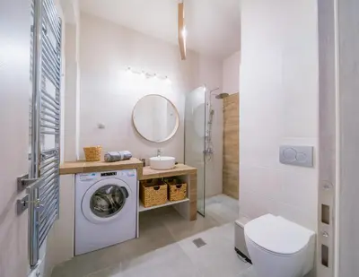 a bathroom with a washing machine and a sink at Brand new aprtm touching Acropolis in Athens