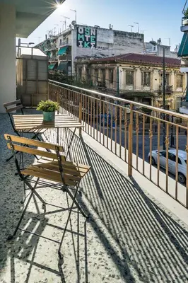 a table and chairs sitting on top of a balcony at 1 BR Apt In Petralona 15 Minutes From Acropolis in Athens