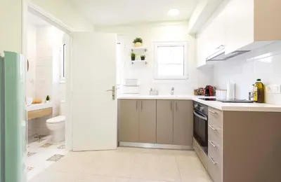 a white kitchen with a sink and a toilet at 1 BR Apt In Petralona 15 Minutes From Acropolis in Athens