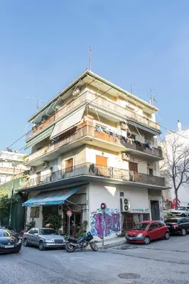 a building with cars parked in front of it at 1 BR Apt In Petralona 15 Minutes From Acropolis in Athens