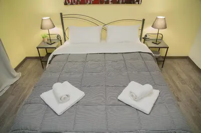 a bedroom with a bed with two white towels on it at Cozy renovated flat in Koukaki in Athens