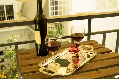 two glasses of wine on a table with a bottle of wine at Cozy renovated flat in Koukaki in Athens