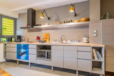 a kitchen with white cabinets and blue appliances at Lux clevercomfy appartmentthe center of Athens in Athens