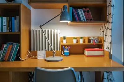 a desk with a lamp and a book shelf at Lux clevercomfy appartmentthe center of Athens in Athens