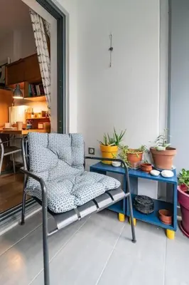a room with a chair and a table with potted plants at Lux clevercomfy appartmentthe center of Athens in Athens