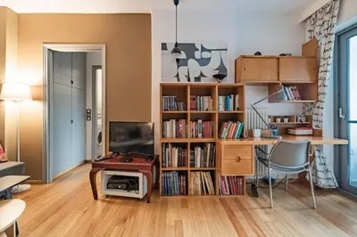 a living room with a desk and a tv and a book shelf at Lux clevercomfy appartmentthe center of Athens in Athens