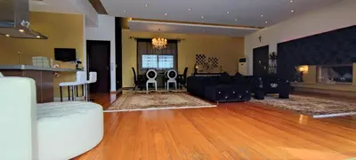 a large living room with a couch and a table at Unique Villa Melia Lagonisi in Kalívia Thorikoú
