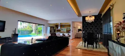 a living room with a black couch and a table at Unique Villa Melia Lagonisi in Kalívia Thorikoú
