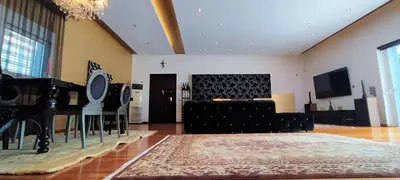 a living room with a couch and a piano at Unique Villa Melia Lagonisi in Kalívia Thorikoú